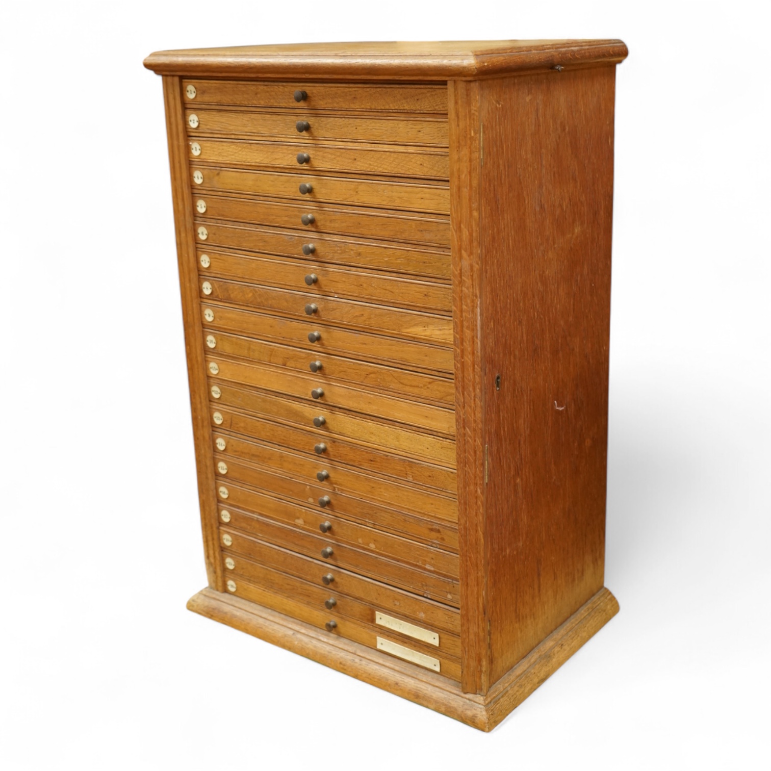 An early 20th century oak and plywood microscope slide cabinet, comprising of 20 drawers with ivorine numbers, containing slide holders and samples on slides from Orpington Hospital, dimensions; 55cm high, 37cm wide, 24.